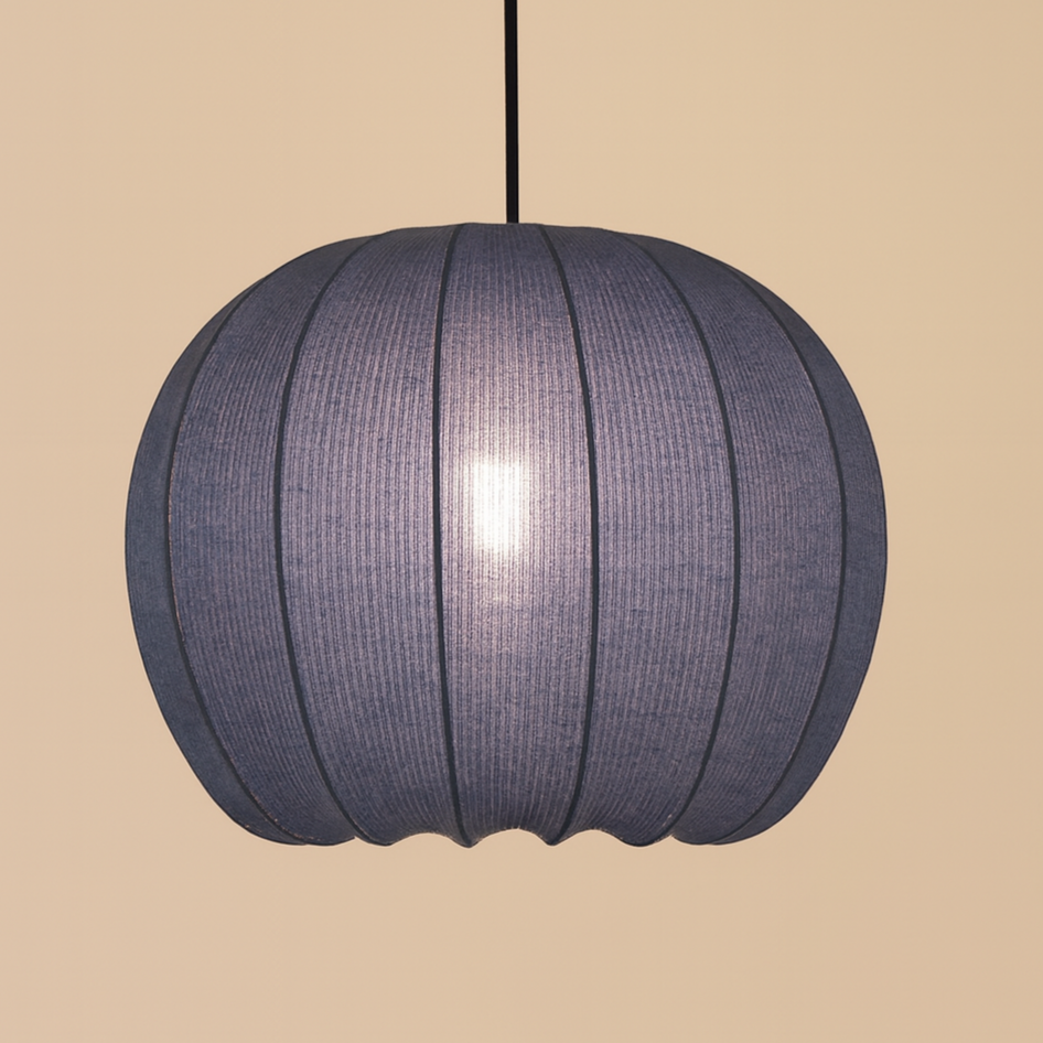 Blue pendant lamp hanging against a beige wall