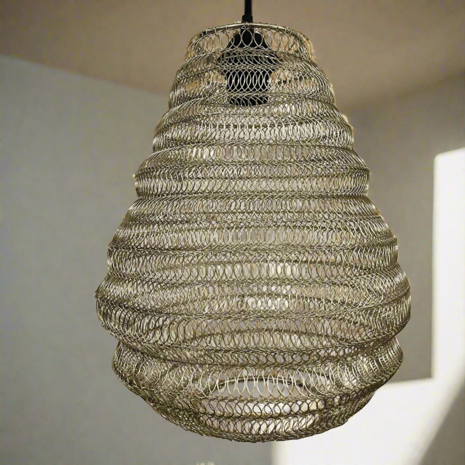 Bring a Moroccan twist to your home décor with the delicately crafted Casablanca ceiling light. Made in an intricate design from silver metal wire this large statement light would look fabulous in both living and dining spaces, as well as bedrooms. When switched on the light shines through the shade creating a spectacular pattern on the ceiling and walls.