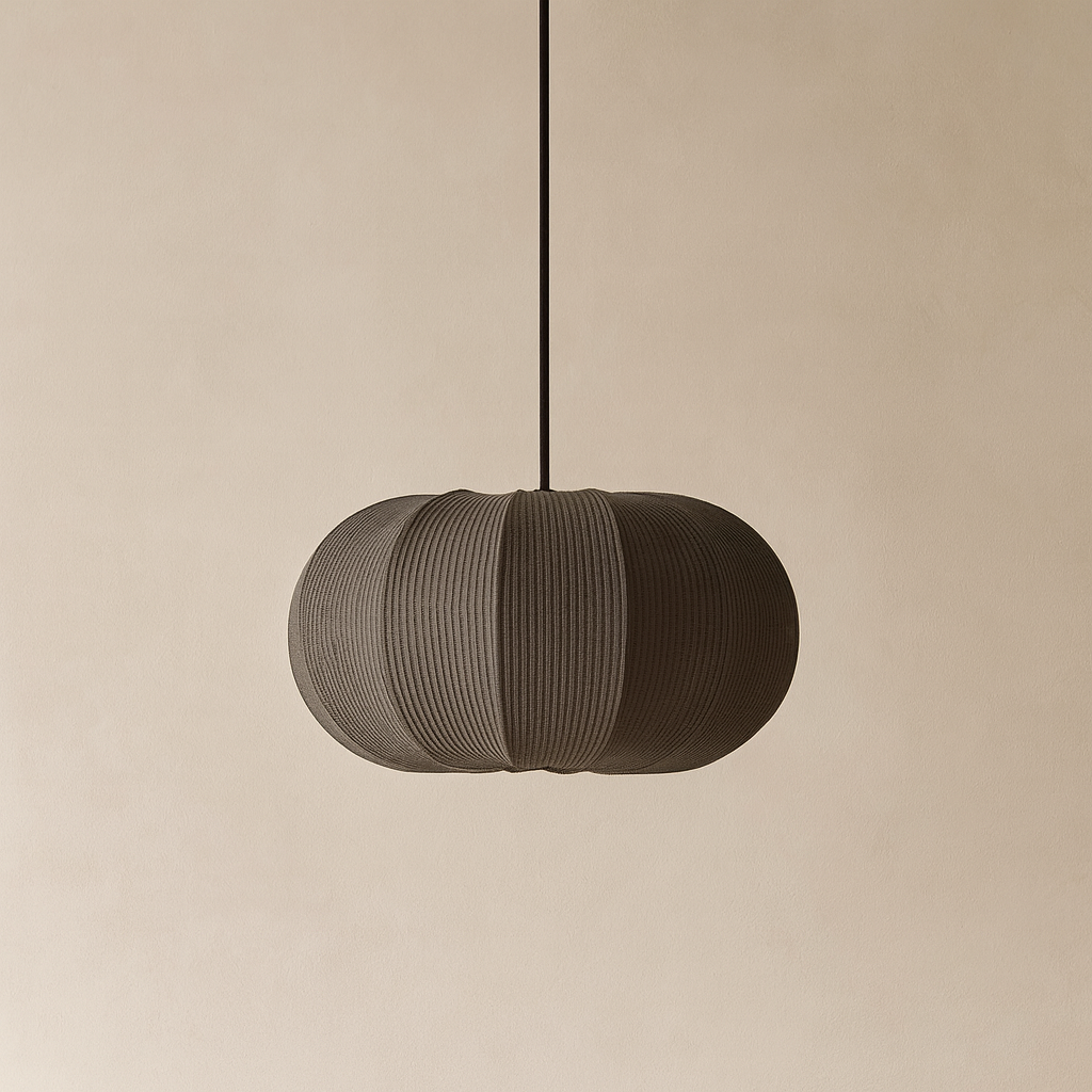 Textured pendant light hanging against a beige background