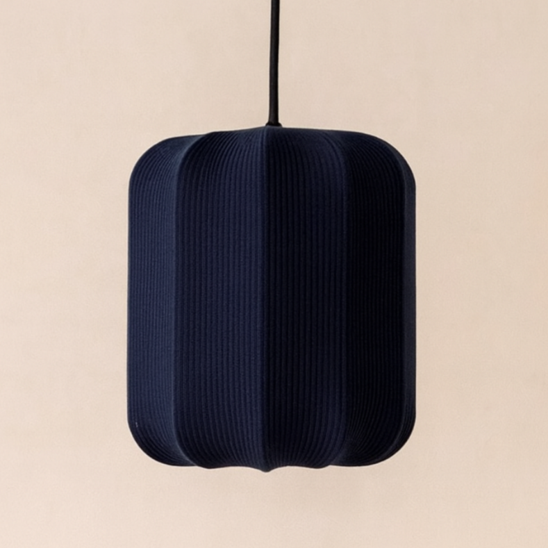 Dark blue pendant lamp on a beige background