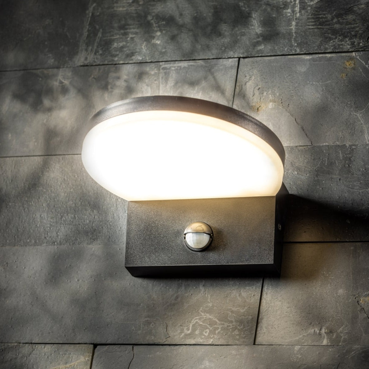 Our Aubrey black plastic ABS plastic outdoor wall mounted round outdoor light with built in LED's and motion sensor would look perfect in a modern or more traditional home design. Outside wall lights can provide atmospheric light in your garden, at the front door or on the terrace as well as a great security solution. It is designed for durability and longevity with its robust material producing a fully weatherproof and water resistant light fitting.