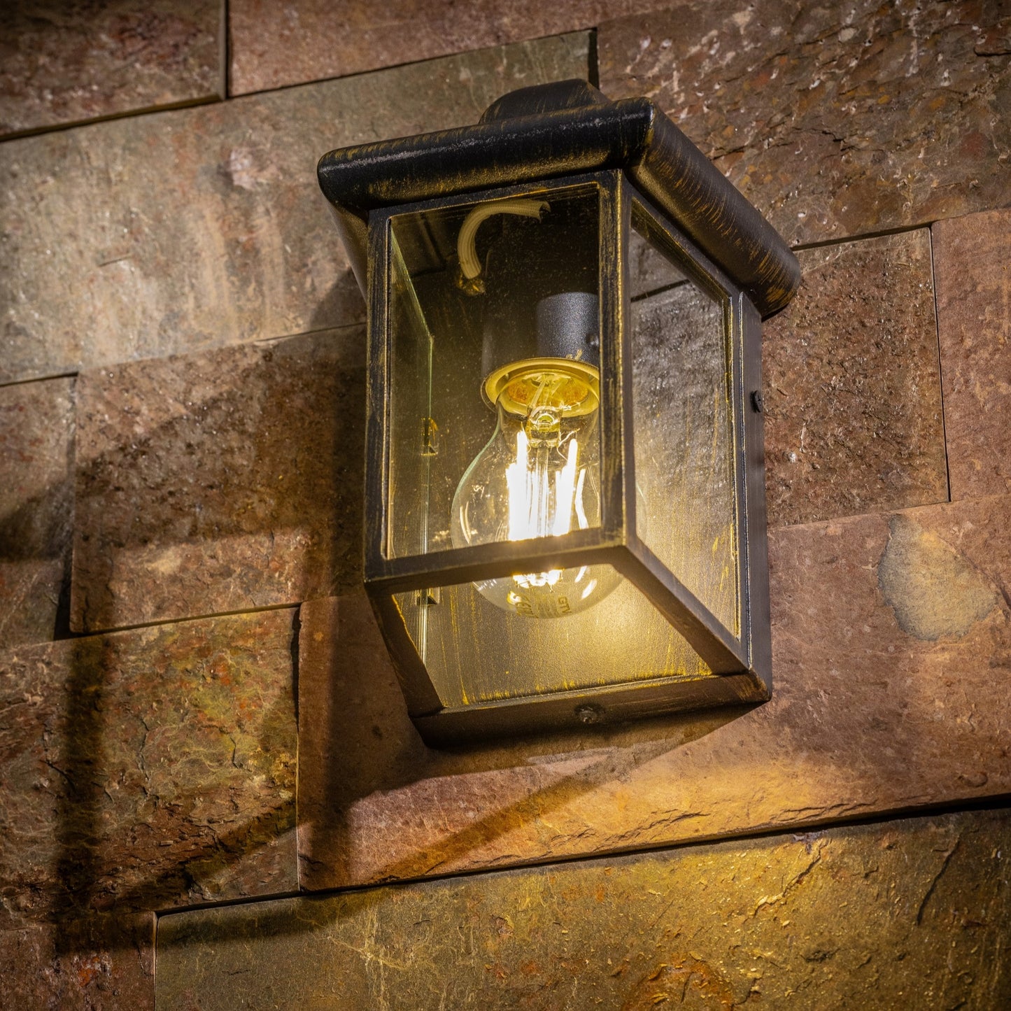 Our Camila wall lantern light is styled with a sophisticated black and bronze colour scheme, allowing the wall light to fit into any home’s style. What’s more, the lantern’s design is a modern take on a traditional styled wall light, creating a flexible look for interior and exterior use. 