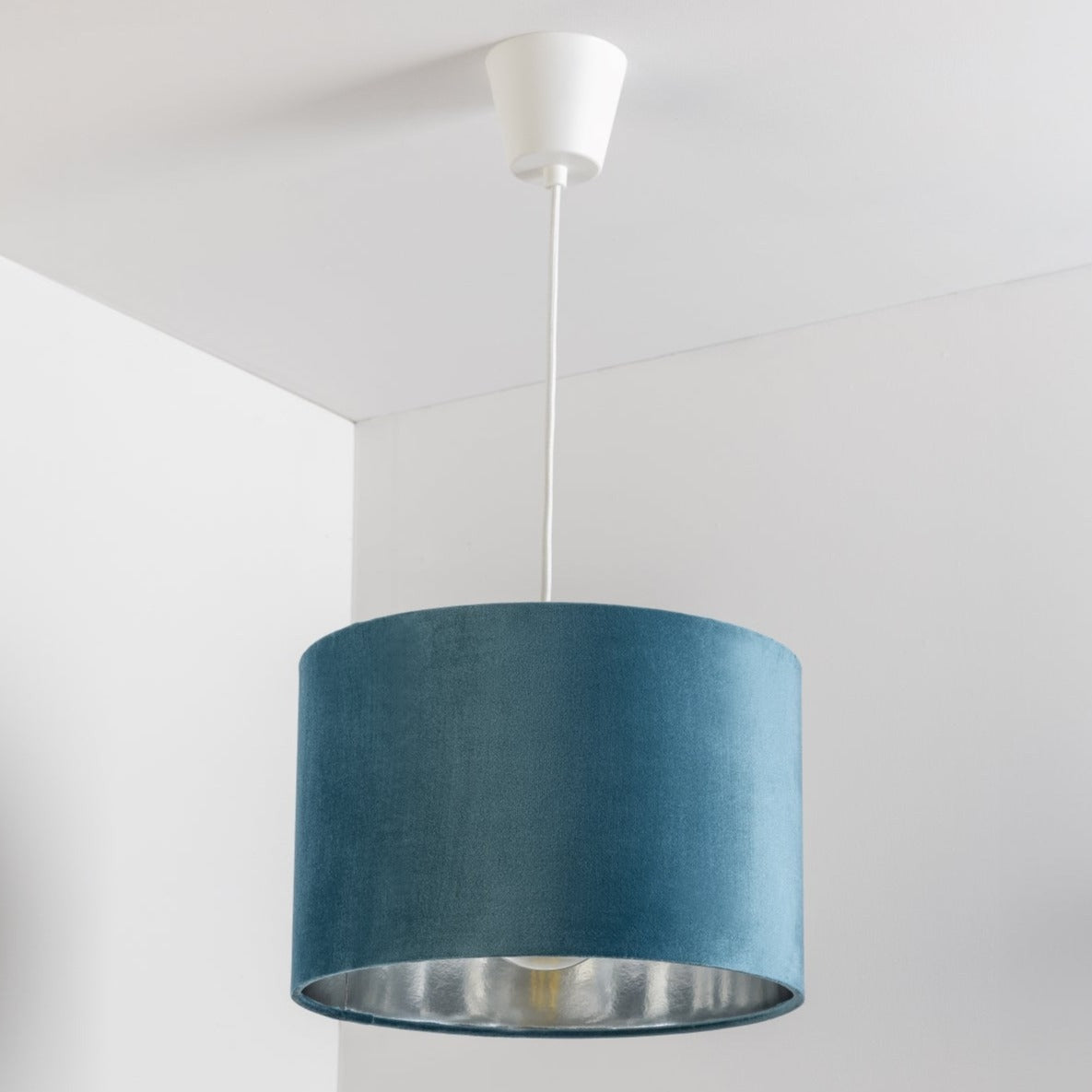 Our Nila velvet shade is sophisticated in appearance and we have designed the shade to suit a range of interiors. Easy to fit, it’s crafted from high-quality velvet on the outer and has a reflective silver metallic inner. It's made to fit both a ceiling light or lamp base.