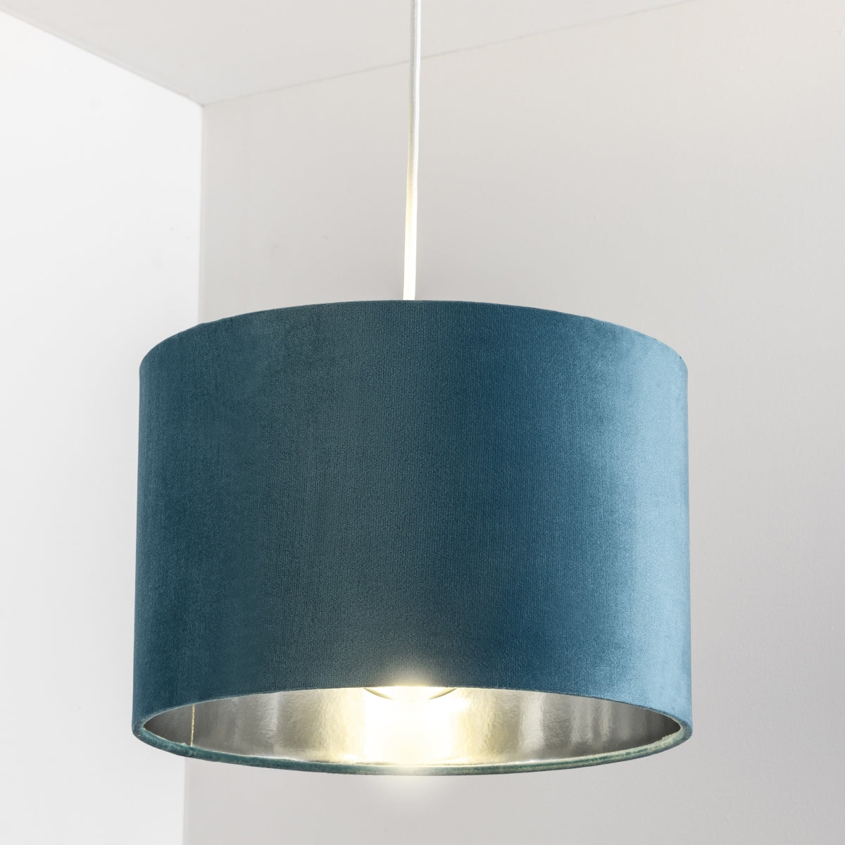 Our Nila velvet shade is sophisticated in appearance and we have designed the shade to suit a range of interiors. Easy to fit, it’s crafted from high-quality velvet on the outer and has a reflective silver metallic inner. It's made to fit both a ceiling light or lamp base.