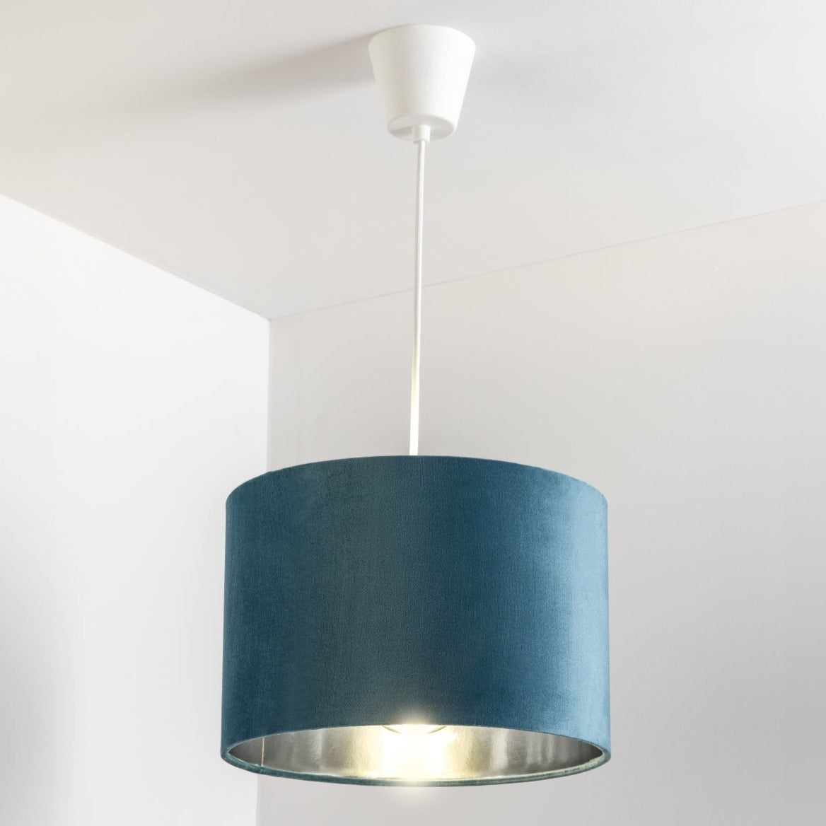 Our Nila velvet shade is sophisticated in appearance and we have designed the shade to suit a range of interiors. Easy to fit, it’s crafted from high-quality velvet on the outer and has a reflective silver metallic inner. It's made to fit both a ceiling light or lamp base.