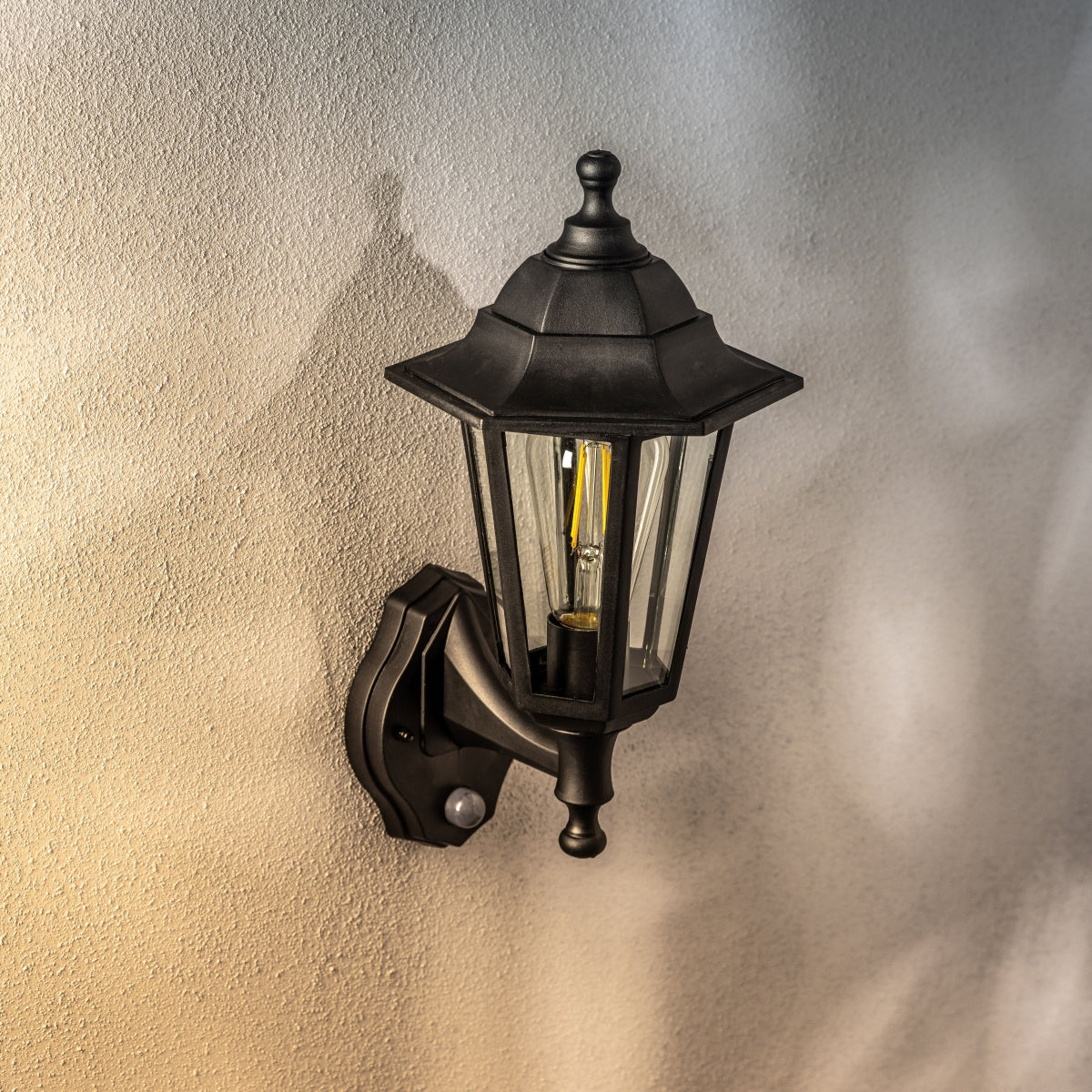 Our Yasmin lantern delivers on style and durability and is a smart choice for your exterior lighting. With its black polycarbonate construction teamed with clear polycarbonate panes and built in motion sensor, this lantern is hardwearing and rust and weatherproof. Built for life outdoors, it has an IP44 rating which means it can withstand the harshest of weather conditions.