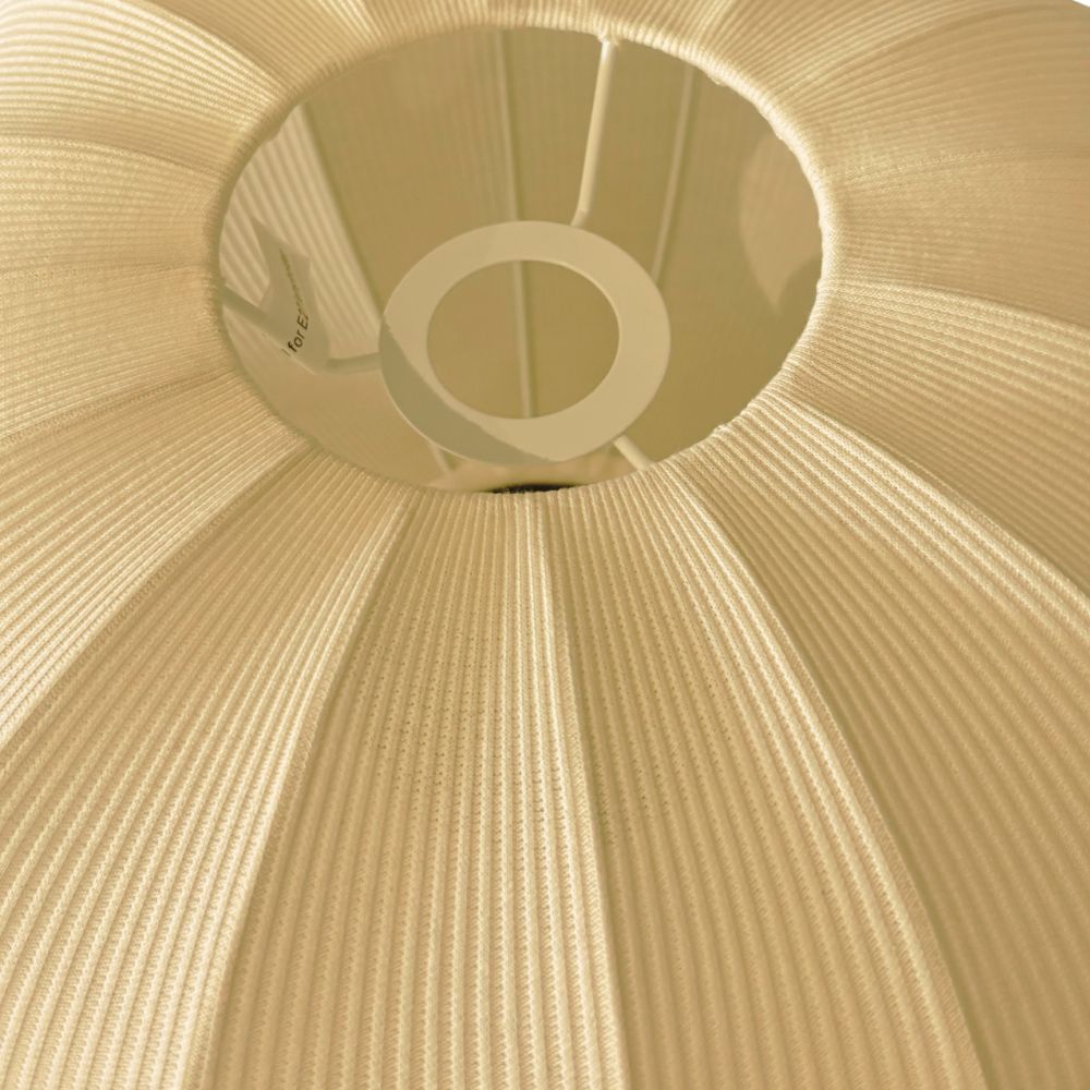 Close-up of a textured cream lampshade with a reflective center.