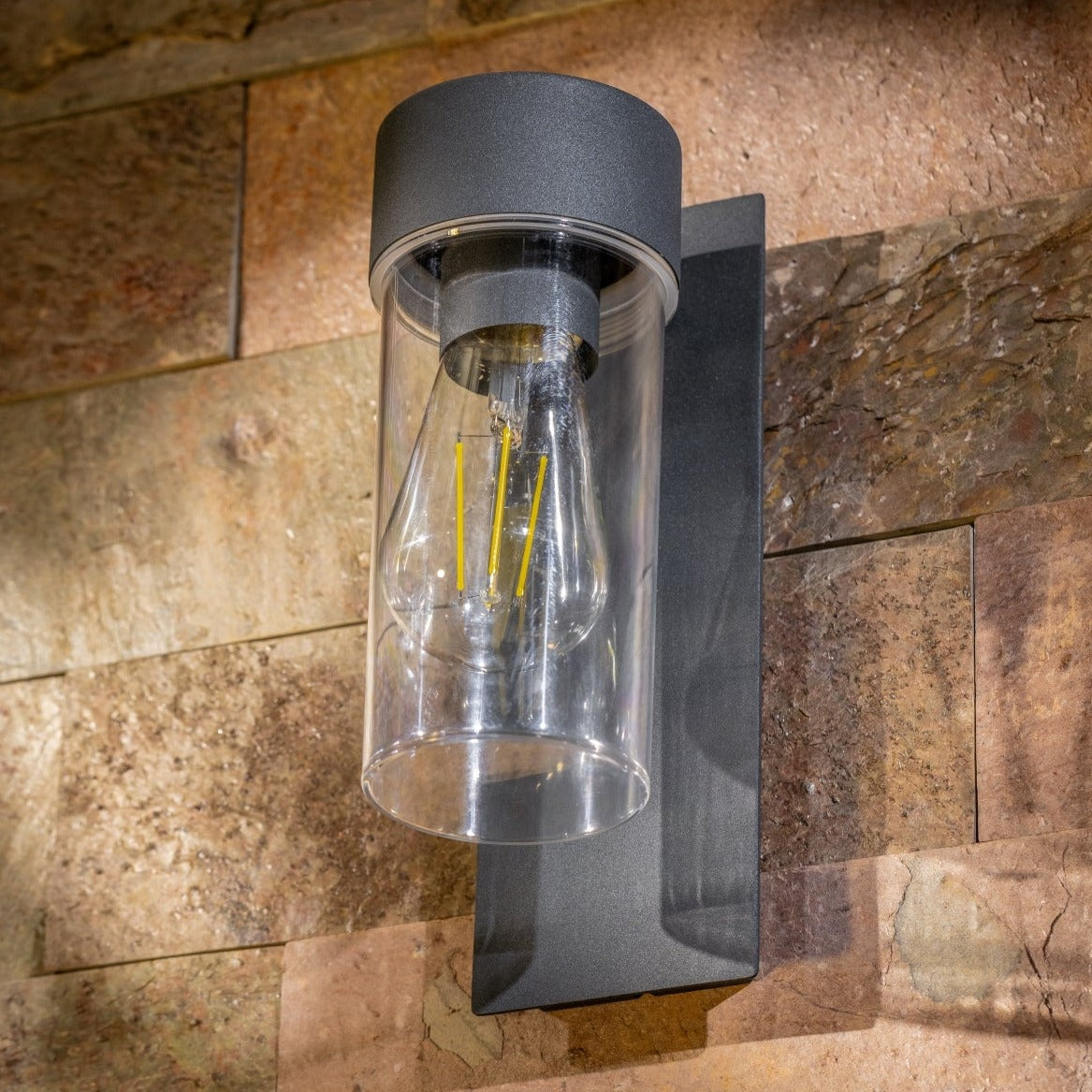 If you’re looking for a modern take on a traditional outdoor wall light, this anthracite wall light is perfect for adding style and protection for your home. This classic design with a contemporary twist, styled with a metal square backplate and fitted with a clear cylinder diffuser that allow the light to shine effectively.