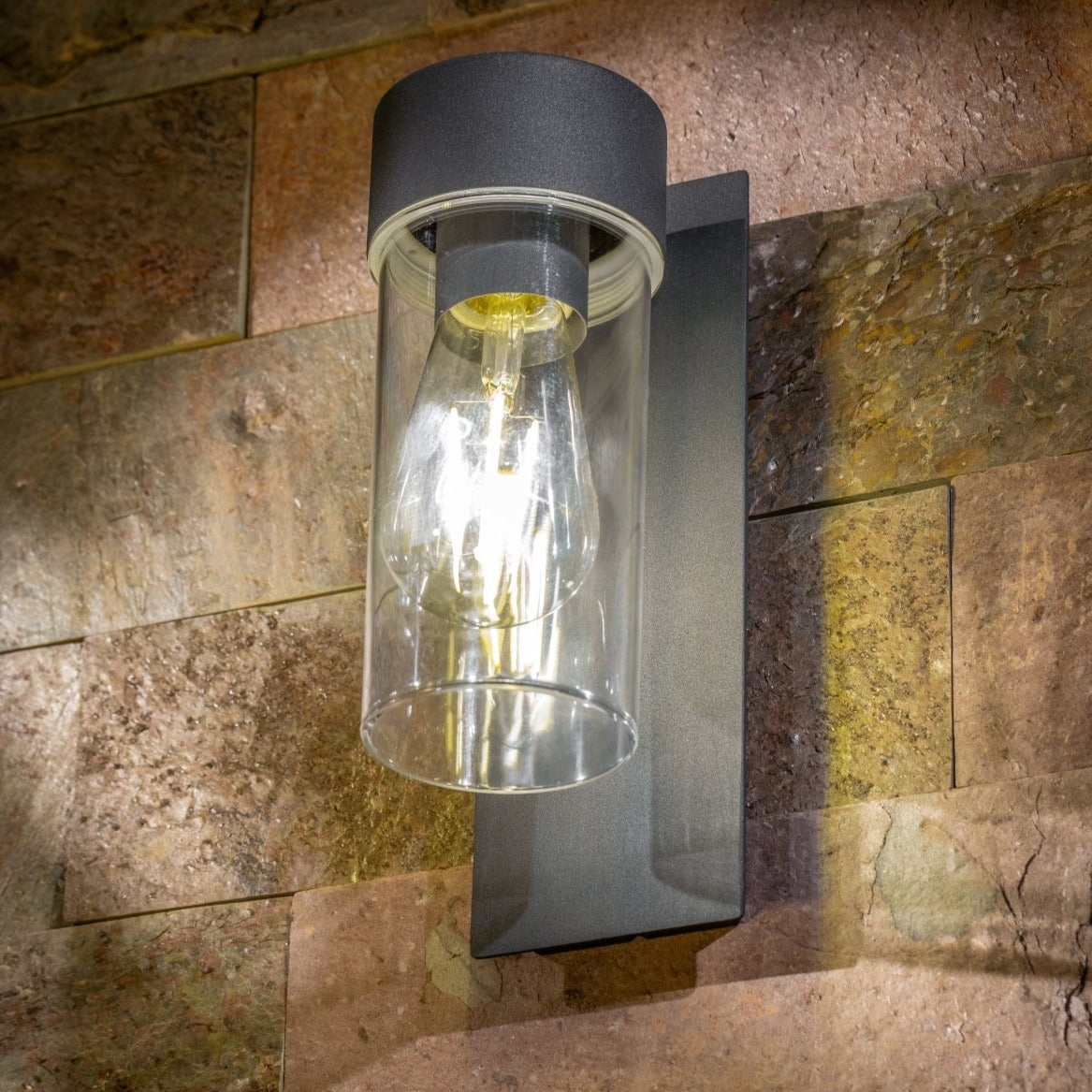 If you’re looking for a modern take on a traditional outdoor wall light, this anthracite wall light is perfect for adding style and protection for your home. This classic design with a contemporary twist, styled with a metal square backplate and fitted with a clear cylinder diffuser that allow the light to shine effectively.