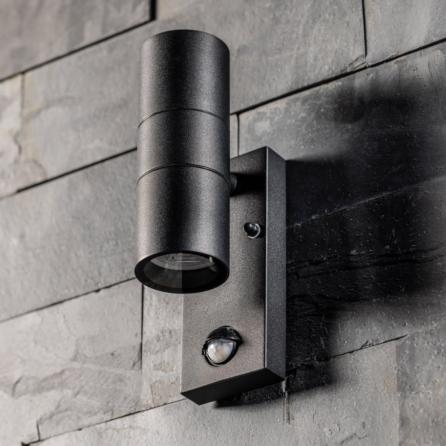 Our Leon outdoor single down light is modern and stylish in its appearance. It comes in a cylinder design mounted on a rectangle back plate complete with clear glass diffuser and built in PIR motion sensor. It is designed for durability and longevity with its robust material producing a fully weatherproof and water resistant light fitting