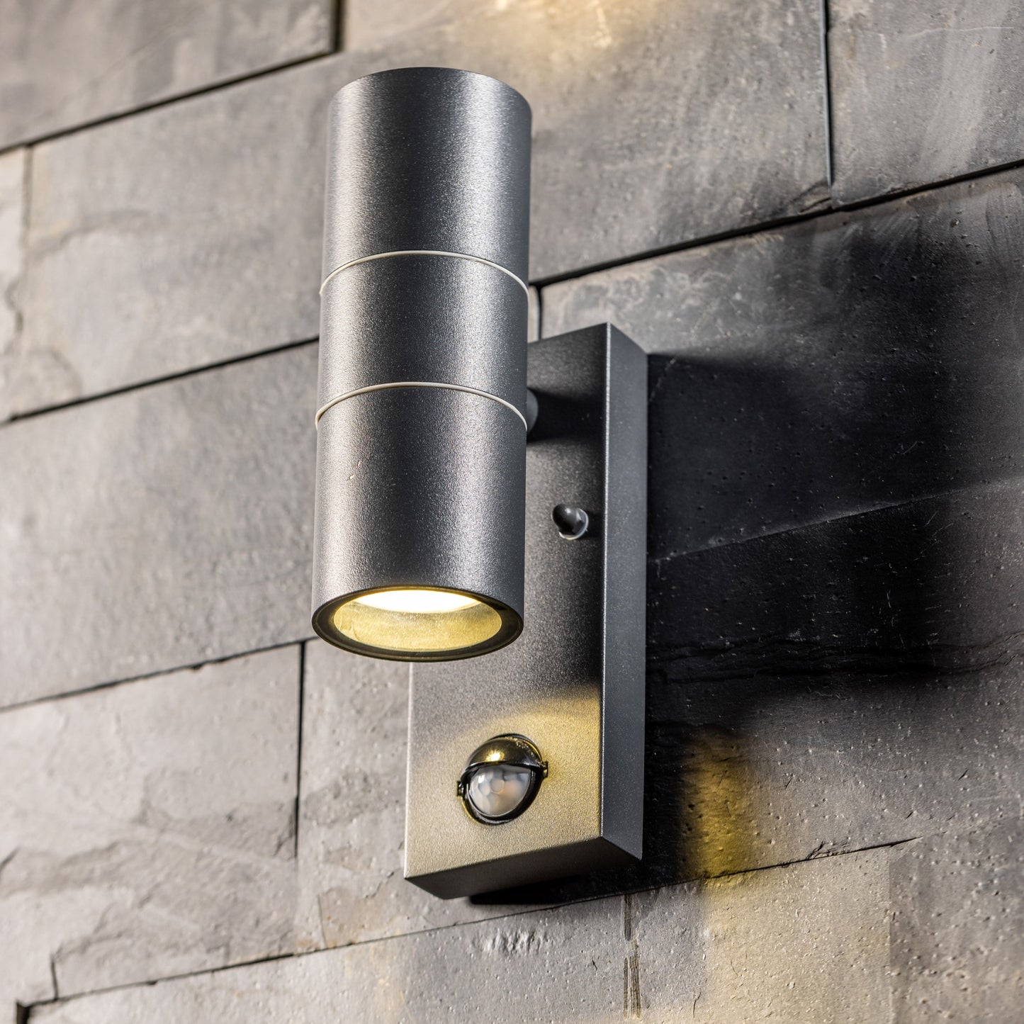 Our Mia outdoor single down light is modern and stylish in its appearance. It comes in a cylinder design mounted on a rectangle back plate complete with clear glass diffuser and built in PIR motion sensor. It is designed for durability and longevity with its robust material producing a fully weatherproof and water resistant light fitting