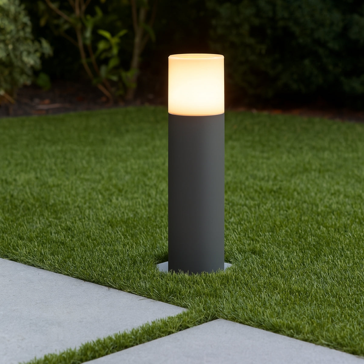 Garden lamp post on grass with a blurred background