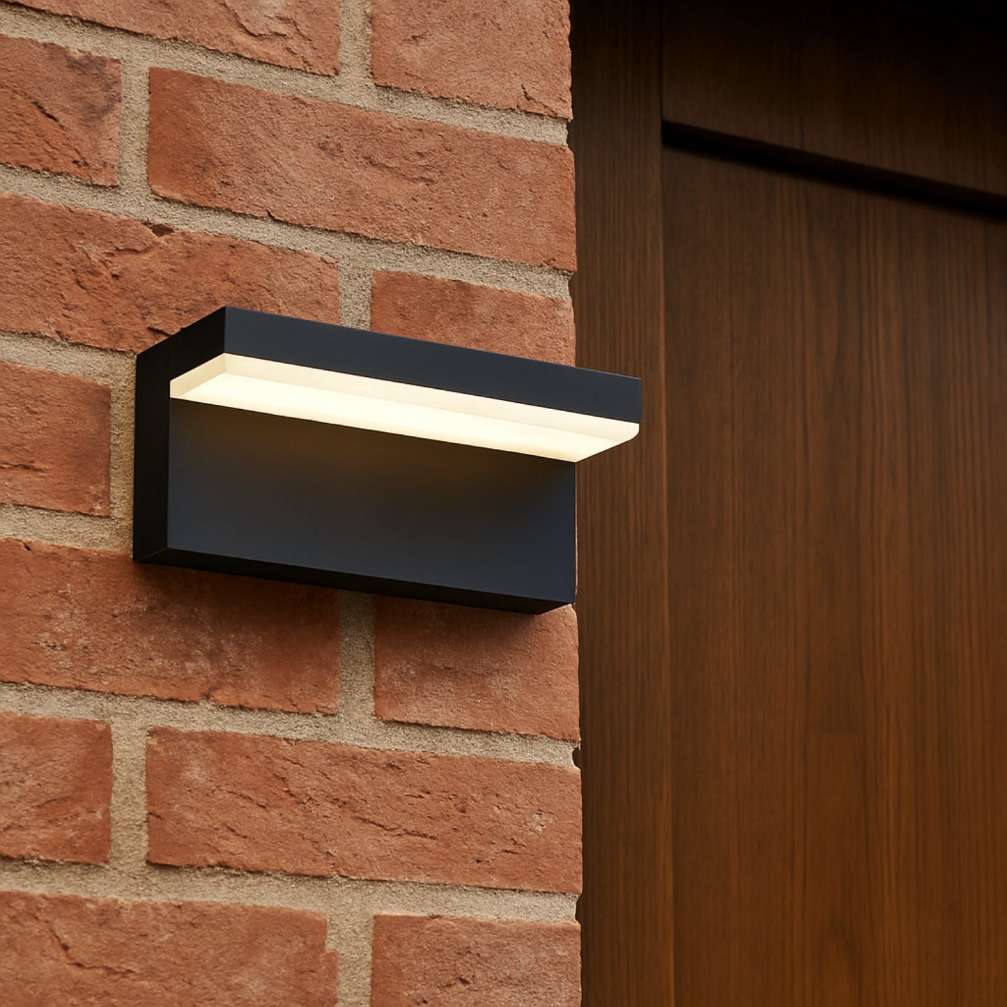 Black outdoor wall light fixture on a brick wall