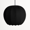 Black pendant lamp with ribbed texture on a white background