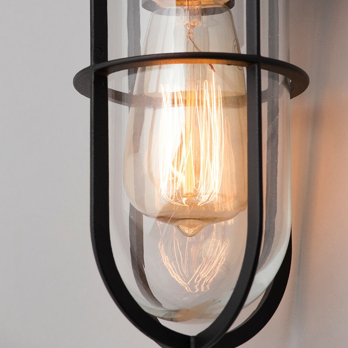 This wall lantern light is styled with a sophisticated black and glass colour scheme, allowing the wall light to fit into any home’s style. What’s more, the lantern’s design is a modern take on a traditional styled wall light, creating a flexible look for interior and exterior use. The addition of the glass shade adds an eloquent appearance when affixed to the wall, ensuring that your home’s looks are not disturbed by our premium wall lantern light.