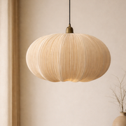 Beige pendant light hanging in a room with a neutral color scheme