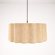 Pendant light with a natural woven shade on a white background