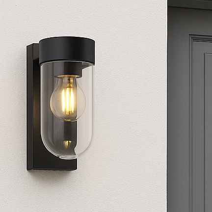 Gray door with a black wall-mounted light fixture on a white wall.