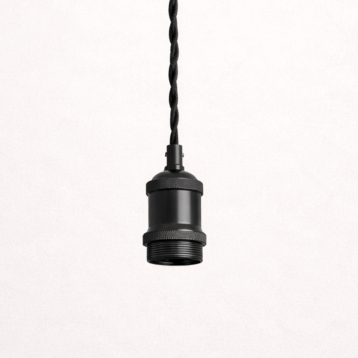 Black pendant light hanging from a white ceiling