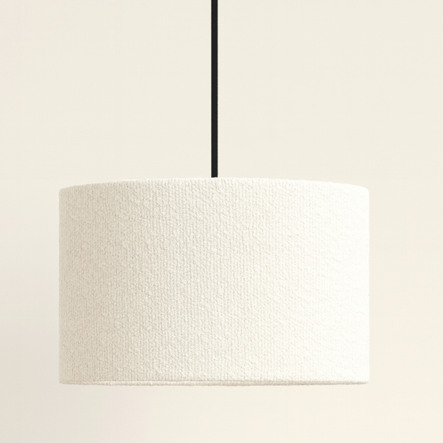 Minimalist pendant light with a textured white shade on a plain background