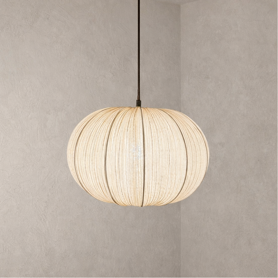 Spherical pendant light with woven design on a plain background