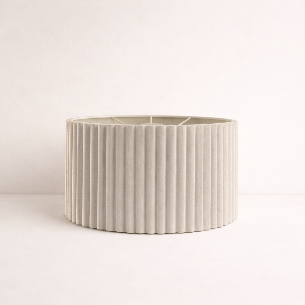 Beige ceramic planter with ribbed texture on a light pink background