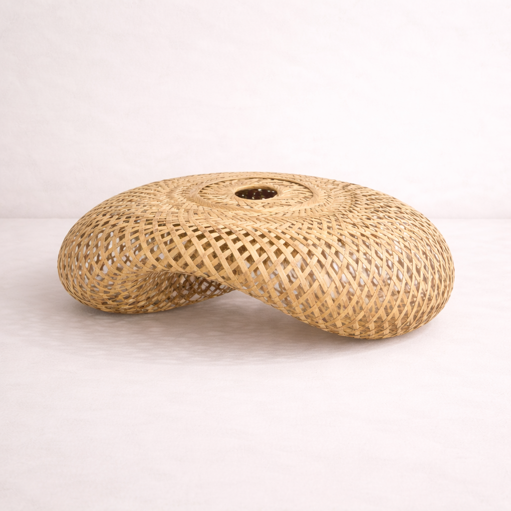 Woven natural material cushion on a white background