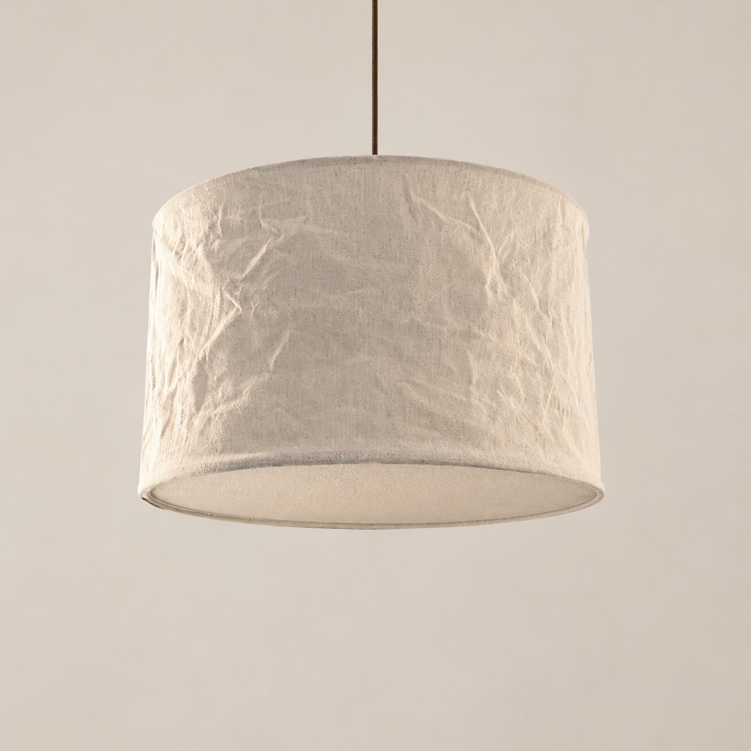 Ceiling light fixture with textured white shade on a plain background