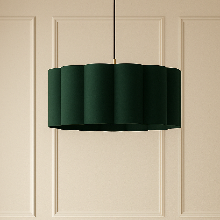 Dining area with a round table, chairs, and a green pendant light against a beige paneled wall.