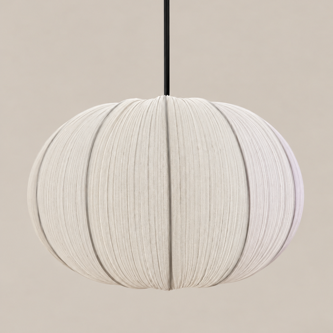 A modern spherical pendant light with a textured, pleated fabric shade in a warm off-white color, suspended by a thin black cord against a solid beige background.