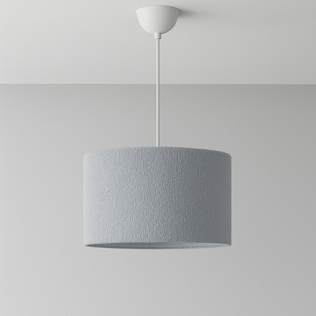 Grey pendant lamp hanging against a plain white wall