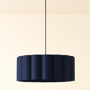 Navy blue pendant light with gold fixture on a beige background