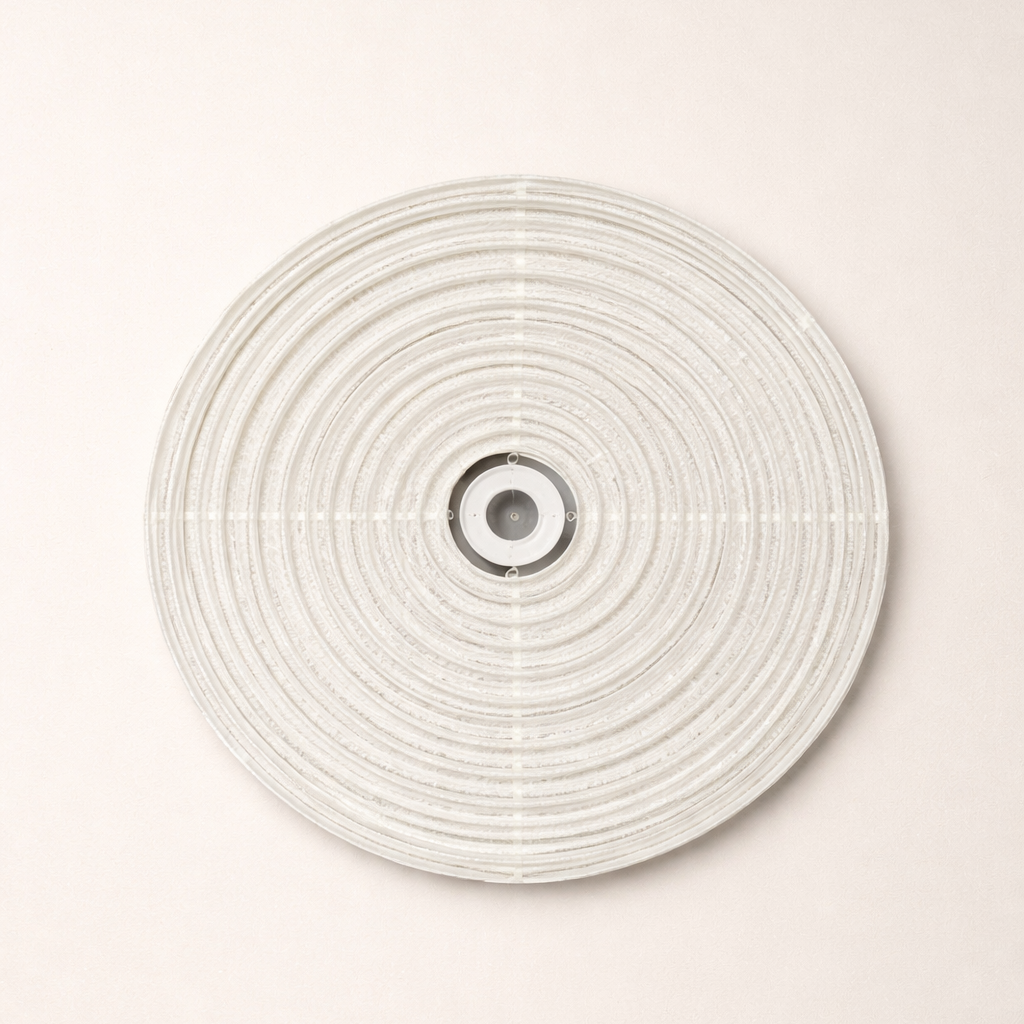Round woven wall art piece on a white background