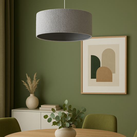 Dining room with round wooden table, green chairs, and a gray pendant light.