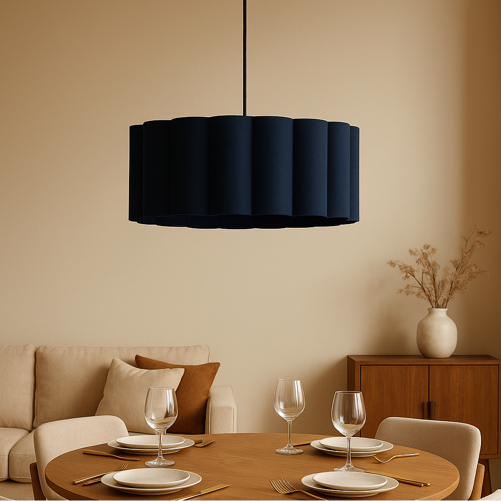 Modern dining room with a black pendant light, round table, and beige walls.