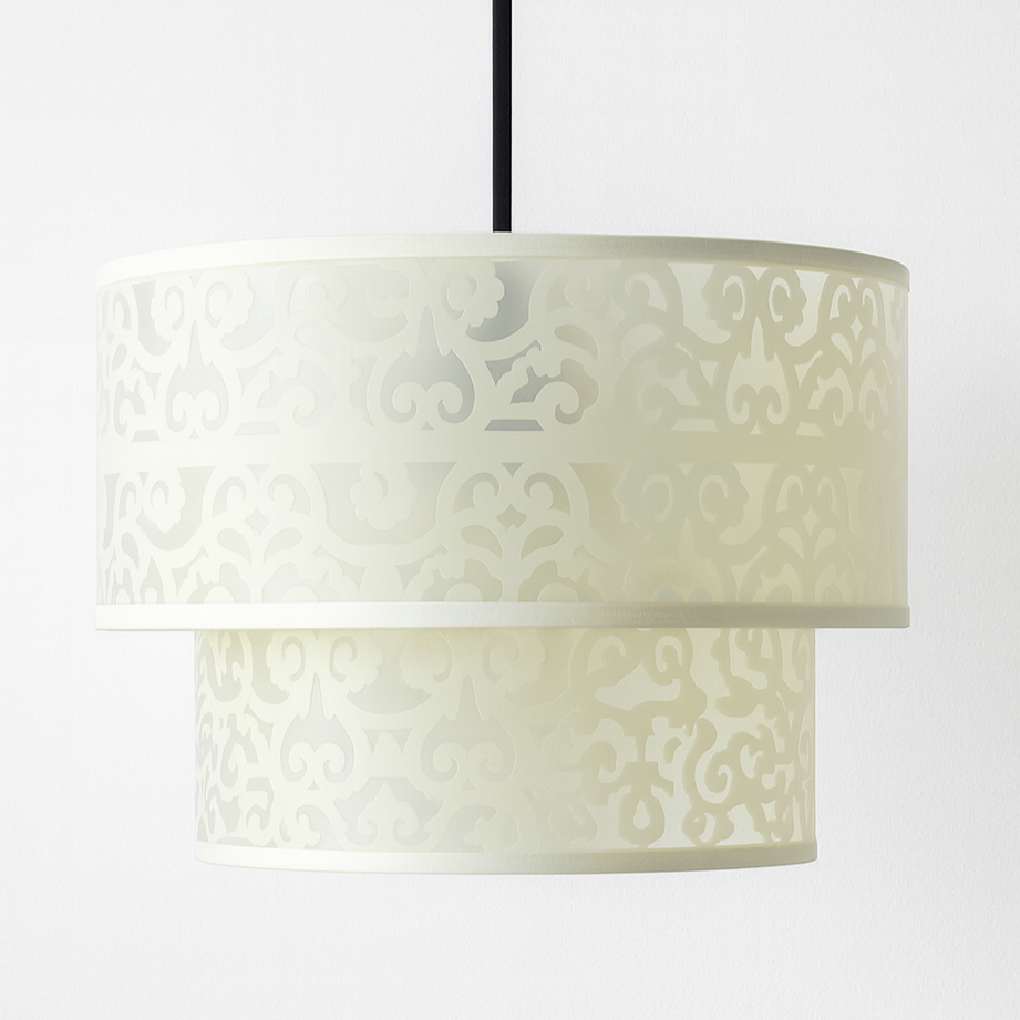 Decorative lamp with patterned shade on a white background
