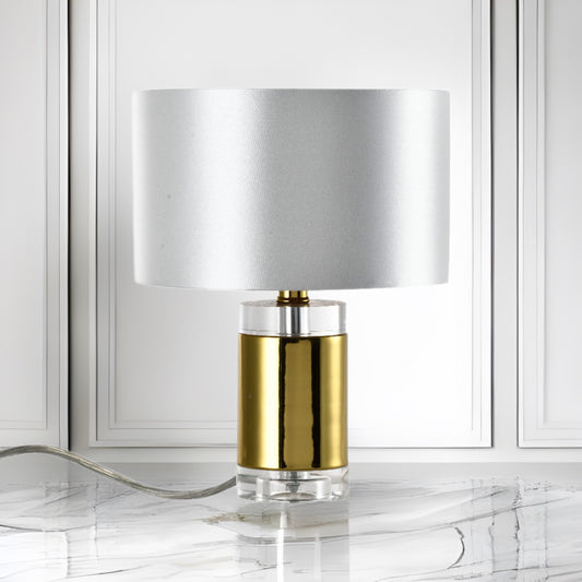 Introducing our Laya table lamp with its elegant crystal and golden finish it will be sure to make a stylish addition to any living space. It features a contemporary crystal and gold base and is complimented by a satin silver and gold inner shade that gives the light an undeniably luxurious style.