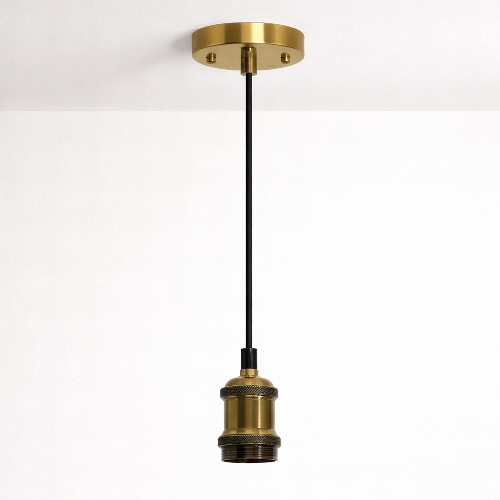Brass pendant light fixture on a white background