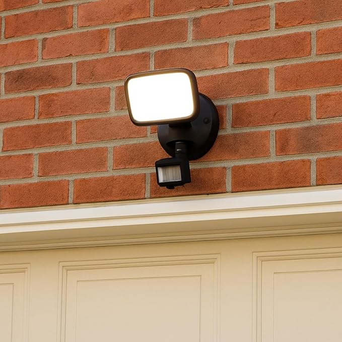 Outdoor security light fixture on a brick wall