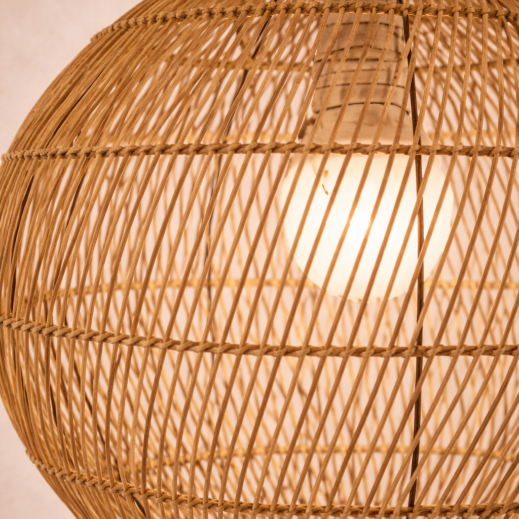 Close-up of a wicker lampshade with a warm glow.