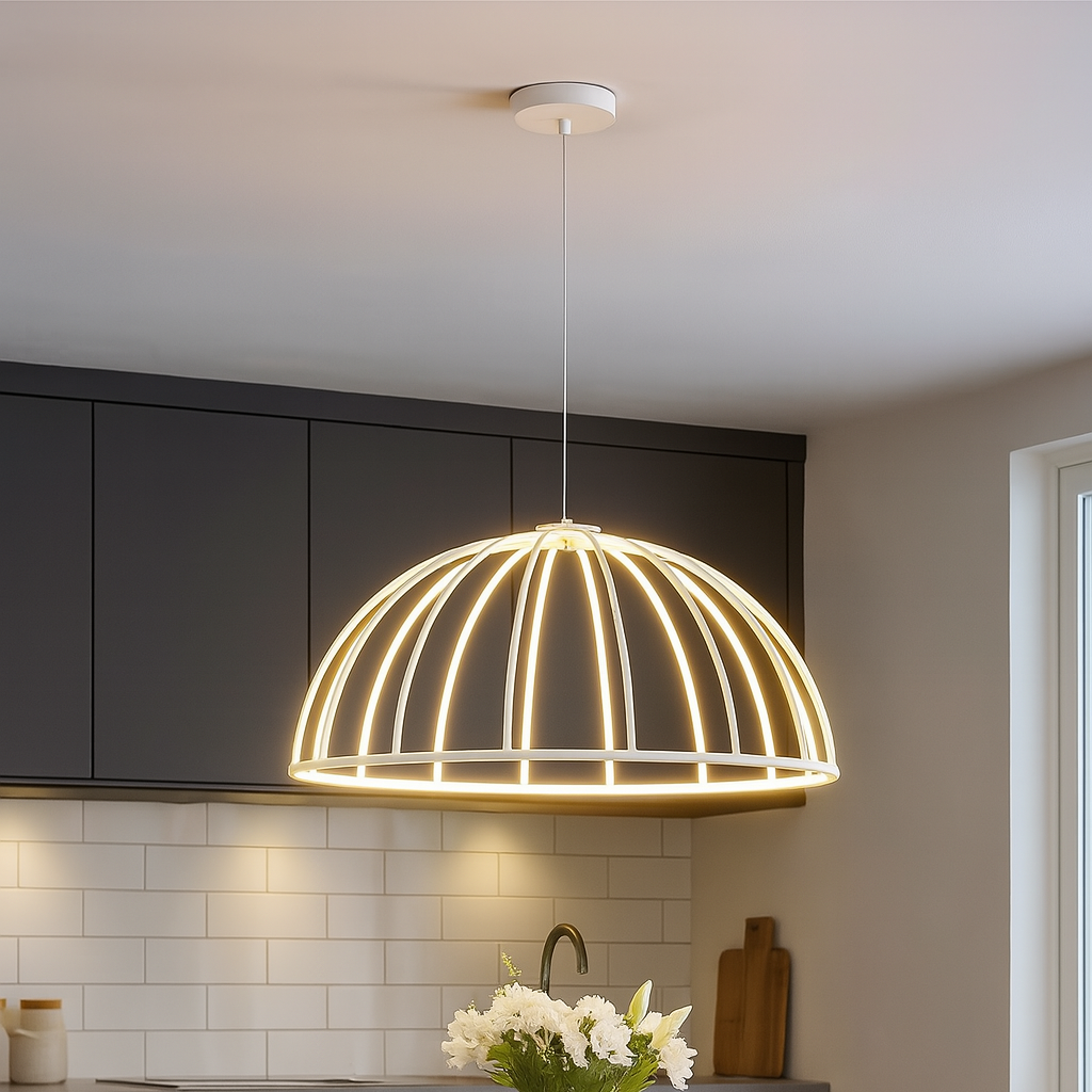 Modern pendant light hanging above a dining table with chairs in a kitchen setting.