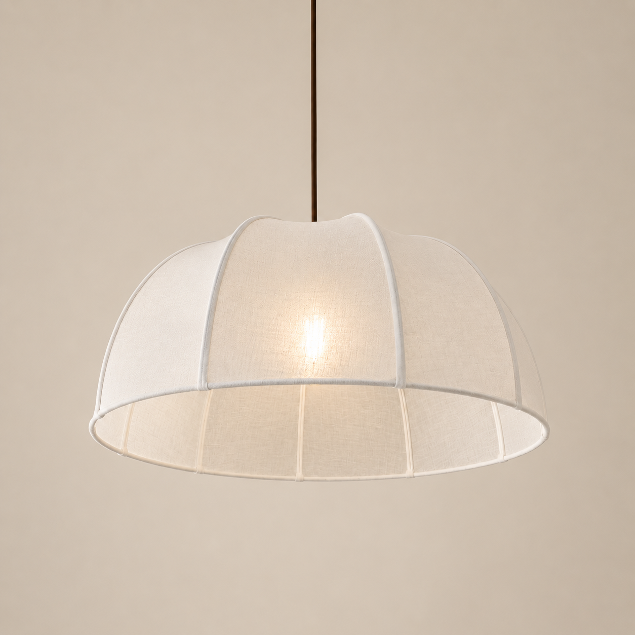 Pendant light with a white mesh shade on a beige background