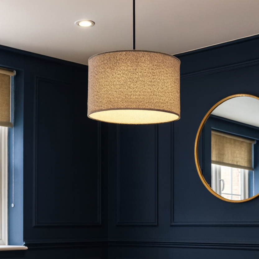 Living room with dark blue walls, a black sofa, and decorative elements.
