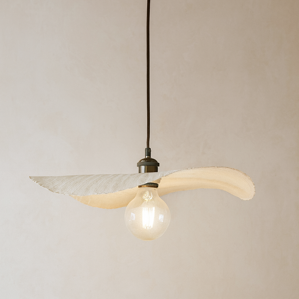 Pendant light with a bulb inside against a plain background