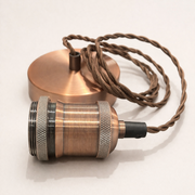 Copper pendant light with braided cable on a white background