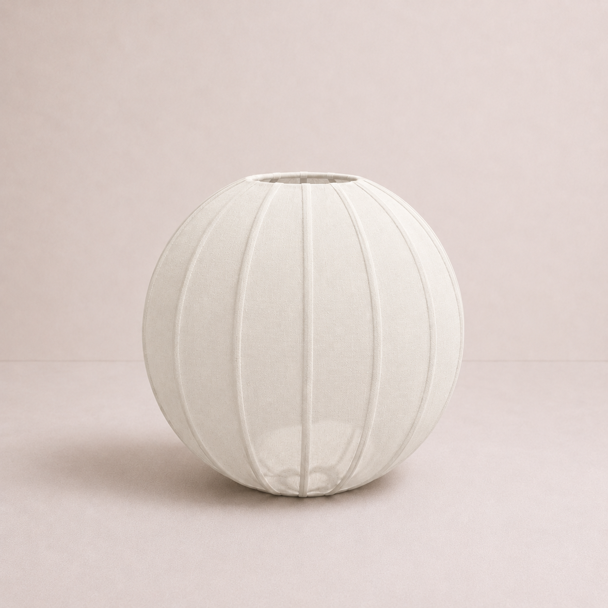 White spherical lampshade on a light pink background
