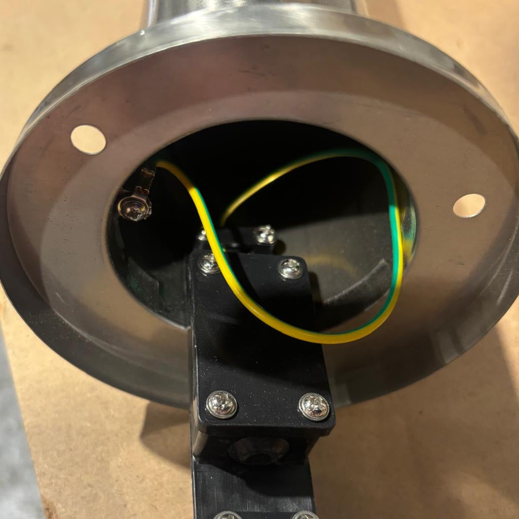 Close-up of a mechanical component with wiring on a cardboard background