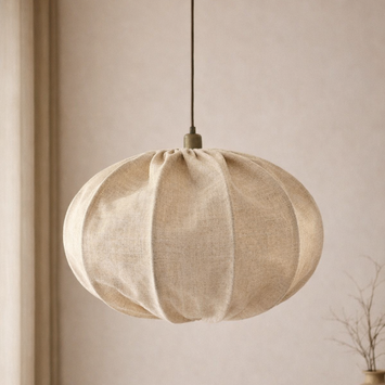 Textured pendant light hanging against a neutral wall with a vase on a shelf.