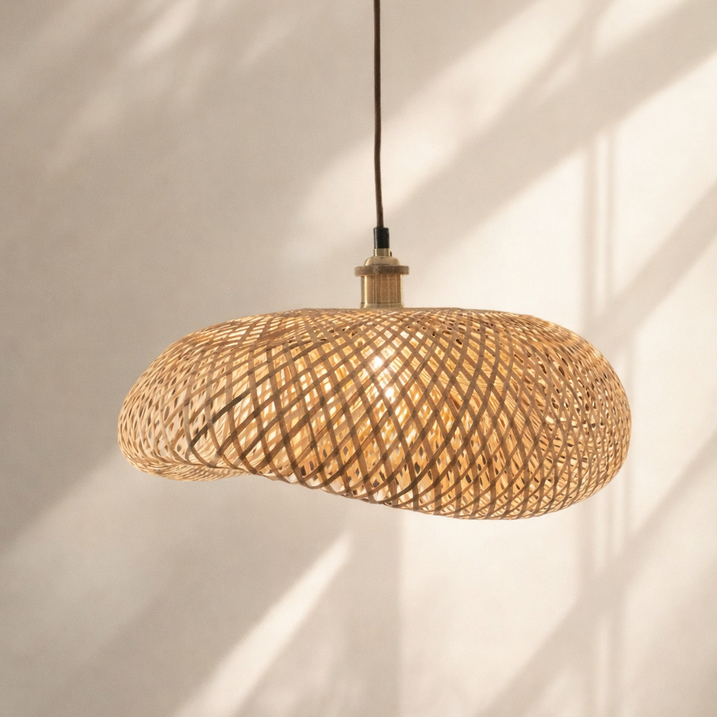 Woven pendant light hanging against a neutral wall with soft shadows