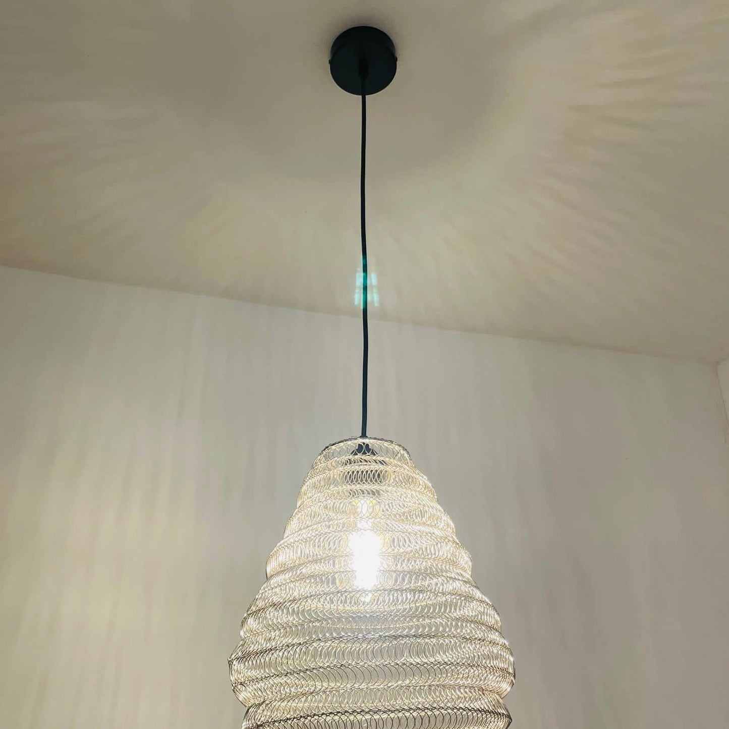 Bring a Moroccan twist to your home décor with the delicately crafted Casablanca ceiling light. Made in an intricate design from silver metal wire this large statement light would look fabulous in both living and dining spaces, as well as bedrooms. When switched on the light shines through the shade creating a spectacular pattern on the ceiling and walls.